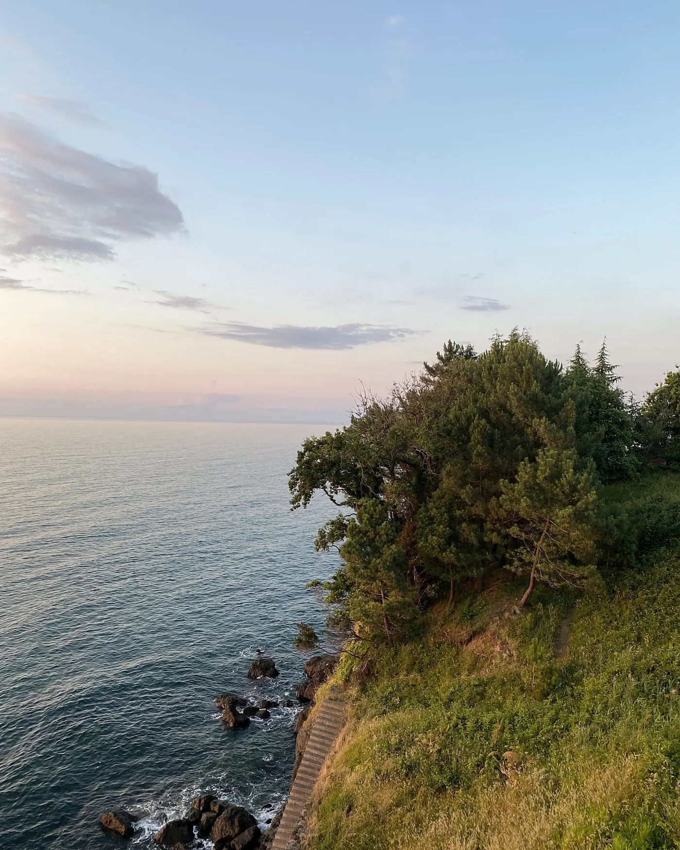 A calm stretch of coast in soft evening light